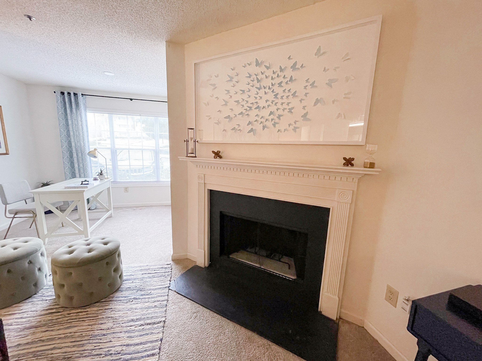 a living room with a fireplace and a table and chairs